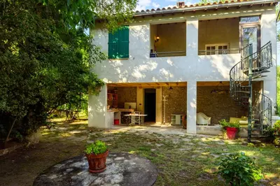 a house next to a river with trees at Moulin St Pierre bord - Au calme en bord de Rivière in Limoux