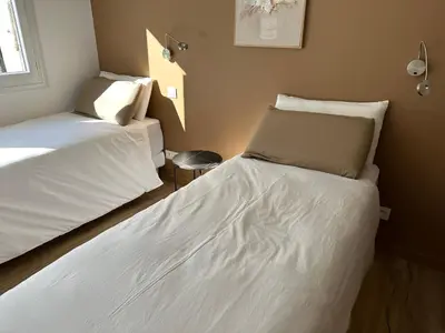 a bedroom with two beds with white sheets at Le repaire du châtaignier, Maison à la campagne, 8 pers, 4 ch, Sidobre in Ferrières