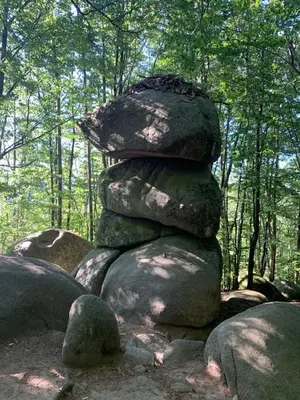 a stack of rocks sitting on top of a forest at Le repaire du châtaignier, Maison à la campagne, 8 pers, 4 ch, Sidobre in Ferrières