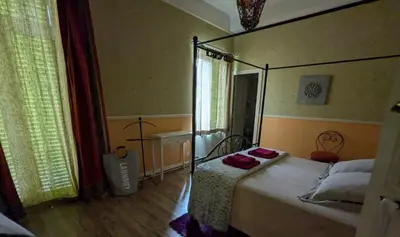 a bedroom with a canopy bed in a room at Grande maison proche Carcassonne 10 p piscine spa sauna Le Grand Chalet Bellevue in Cavanac