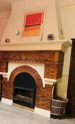 a brick fireplace in a living room at Grande maison proche Carcassonne 10 p piscine spa sauna Le Grand Chalet Bellevue in Cavanac