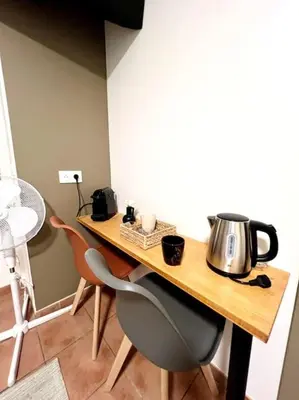 a table with a tea kettle on top of it at Chambre de la bastide 102 in Carcassone