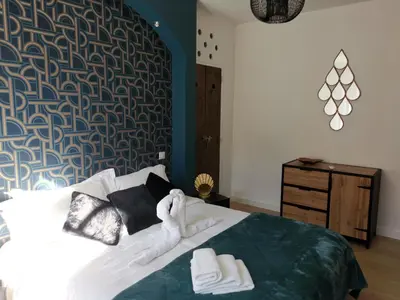 a bedroom with a bed with two towels on it at Le Belvédère St Gimer in Carcassonne