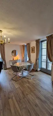 a living room with a table and chairs at Via Narbona in Narbonne