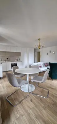 a dining room with a white table and chairs at Via Narbona in Narbonne
