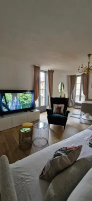 a living room with a large flat screen tv at Via Narbona in Narbonne