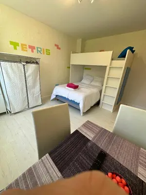 a bedroom with a bed and a bunk bed at Chambre Familiale Tetris in Castres