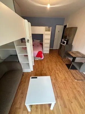 a bedroom with a bed and a couch and a table at Chambre Quattro avec Balcon CASTRES in Castres