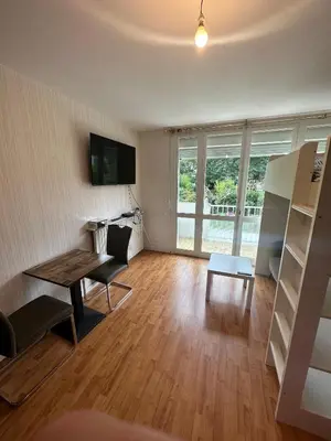 a bedroom with a bunk bed and a white table at Chambre Quattro avec Balcon CASTRES in Castres