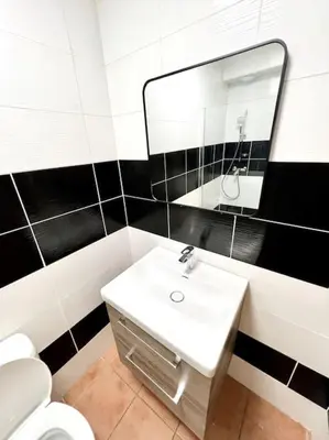 a bathroom with a white sink and a mirror at Les chambres de la bastide - 103 in Carcassonne