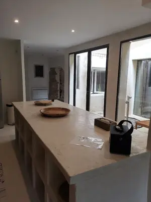 a kitchen with a large island with a counter top at Le Clos Barbacane in Carcassone