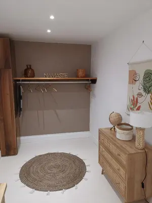 a room with a wooden shelf and a rug at Le Clos Barbacane in Carcassone