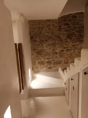 a room with a staircase with a brick wall at Le Clos Barbacane in Carcassone