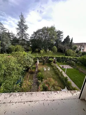 a view of a garden with flowers and trees at Hotel Castres Chambre Simple in Castres
