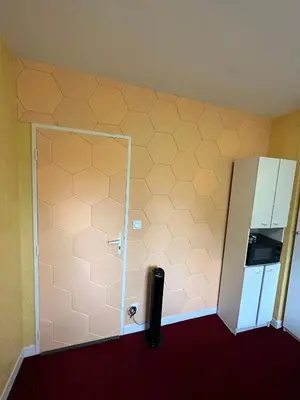 a bedroom with a bed with a polka dot blanket at Hotel Castres Chambre Simple in Castres