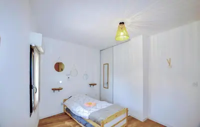 a white room with a bed and a light at 4 Bedroom Gorgeous Home In Tournissan in Tournissan