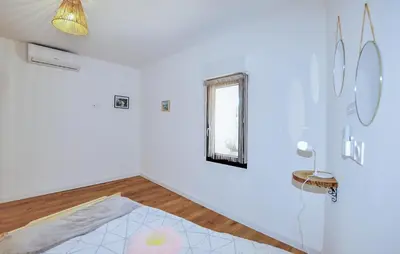 a white room with a table and a window at 4 Bedroom Gorgeous Home In Tournissan in Tournissan