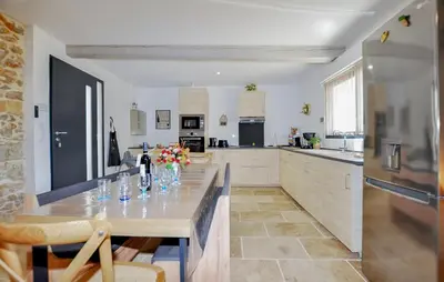 a kitchen with a table with vases of flowers on it at 4 Bedroom Gorgeous Home In Tournissan in Tournissan