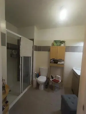 a bathroom with a shower and a toilet and a sink at Charmant T2 proche centre ville in Narbonne