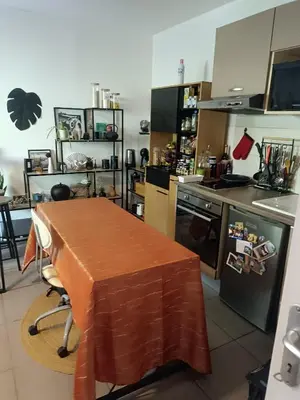 a kitchen with a table and a counter top at Charmant T2 proche centre ville in Narbonne