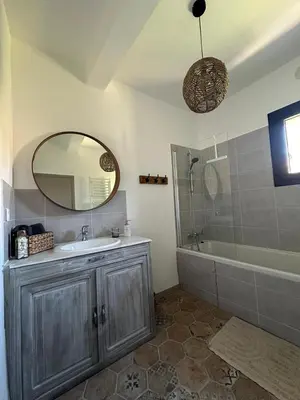 a bathroom with a sink and a mirror and a tub at La Pause Bonheur - La Vagabonde in Luc-sur-Orbieu