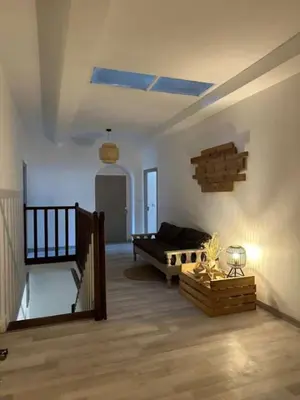 a living room with a couch and a bed at La Pause Bonheur - La Vagabonde in Luc-sur-Orbieu