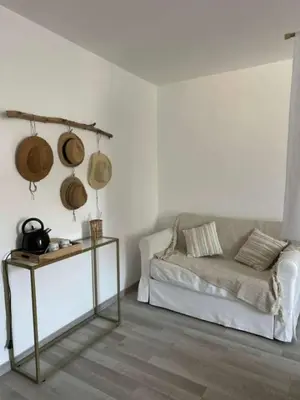 a living room with a couch and a table at La Pause Bonheur - La Vagabonde in Luc-sur-Orbieu