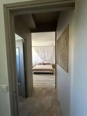 a view of a bedroom with a bed through a doorway at La Pause Bonheur - La Vagabonde in Luc-sur-Orbieu