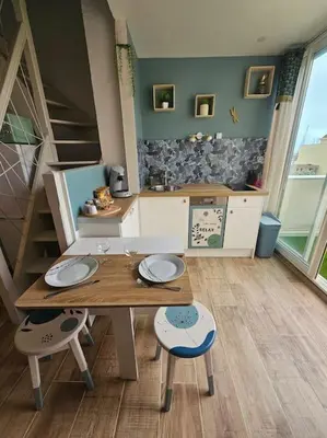 a kitchen with white cabinets and a counter top at Charmant Duplex, Ambiance Nature avec vue sur les bateaux in Gruissan