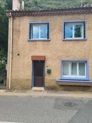 a brick house with a door and two windows at Family Friendly Gite in Quillan in Quillan