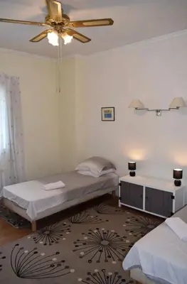 a bedroom with two beds and a ceiling fan at Family Friendly Gite in Quillan in Quillan
