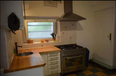 a kitchen with a stove and a sink and a window at Family Friendly Gite in Quillan in Quillan