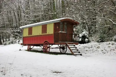 a yellow and red train car in the snow at La Hulotte in Mazamet