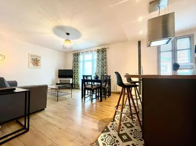 a living room with a kitchen and a dining room at 147 - Vue Cité Médiévale et Parking in Carcassonne
