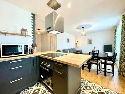 a kitchen with a counter top and a dining room at 147 - Vue Cité Médiévale et Parking in Carcassonne