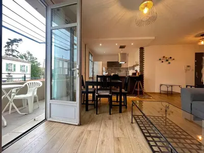 a living room with a table and a dining room at 147 - Vue Cité Médiévale et Parking in Carcassonne