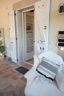 a bedroom with a door open to a closet at Les Deux Petits Pois in Fanjeaux