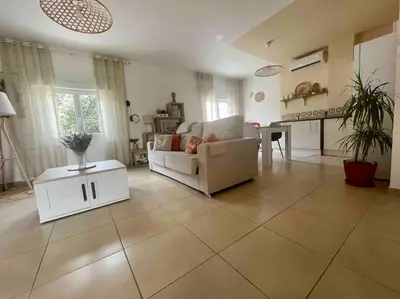a living room with a couch and a table at T2 refait à neuf Calme et agréable in Narbonne