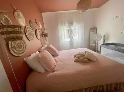 a bedroom with a bed with two stuffed animals on it at T2 refait à neuf Calme et agréable in Narbonne