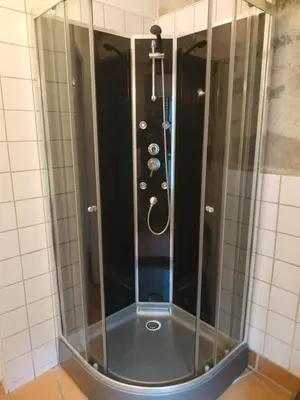 a shower with a glass door in a bathroom at Gite les Volets Verts in Cesseras