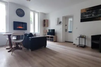 a living room with a couch and a table at T2 Cosy - Proche place Verdun in Castelnaudary