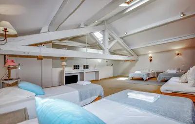 a large room with three beds and a fireplace at Lovely Home In Narbonne in Narbonne