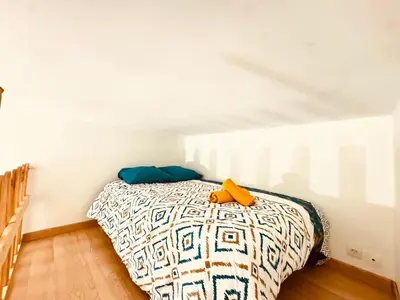 a bedroom with a bed in a white room at Maison avec piscine-climatisation-jardin in Ventenac en Minervois