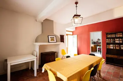 a dining room with a yellow table and yellow chairs at Gîte La Maison des Vendangeurs in Villesèque-des-Corbières