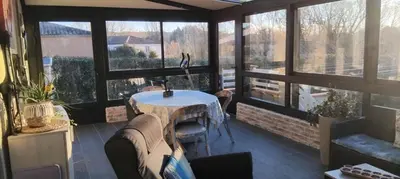 a living room with a couch and a table and guitar at Maison de campagne avec piscine proche Carcassonne in Raissac-sur-Lampy