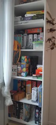 a book shelf filled with lots of food and books at Maison de campagne avec piscine proche Carcassonne in Raissac-sur-Lampy