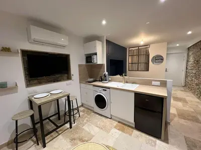a kitchen with a sink and a dishwasher at Le Merveilleux Voyage, Clim in Carcassonne