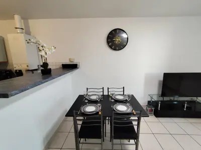 a kitchen with white cabinets and a counter top at Appartement climatisé avec vue sur la cité in Carcassonne