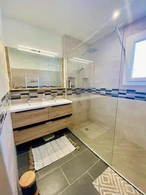 a bathroom with a glass shower and a sink at Maison avec piscine et jardin in Salses-le-Chateau