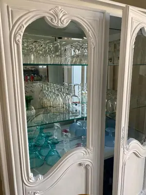 a glass cabinet filled with lots of glasses at Maison avec piscine et jardin in Salses-le-Chateau